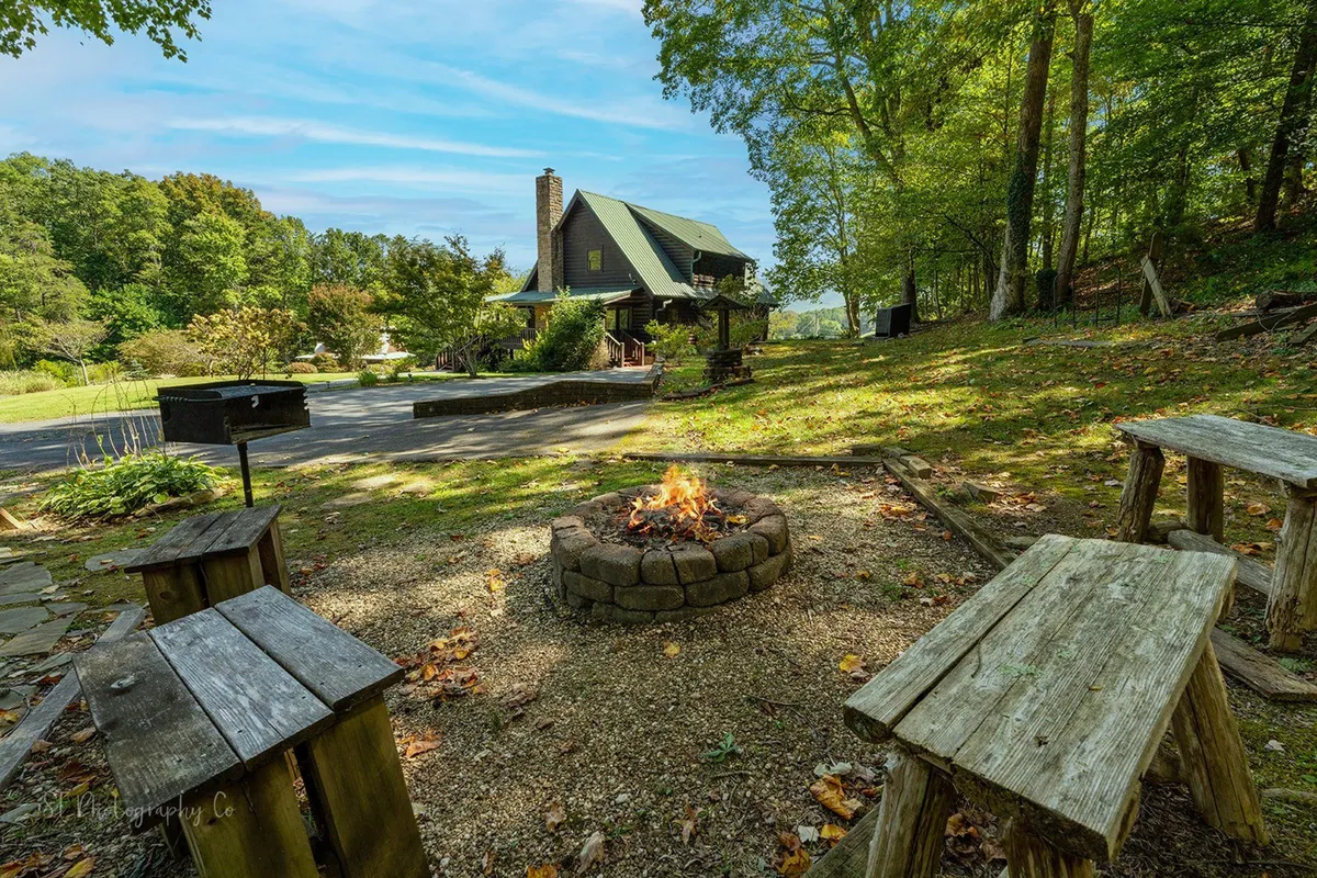 This image centers on a cozy fire pit with wooden benches, lush greenery, and the house in the background. It evokes scenes of campfire gatherings, storytelling, marshmallow roasting, and stargazing, all highlighted in the section's narrative.